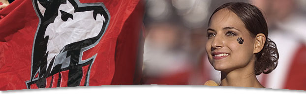 Photo of cheerleader and Huskie flag