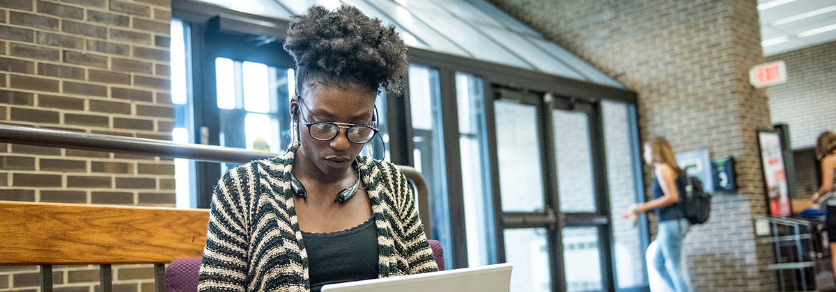 student working on laptop in Library