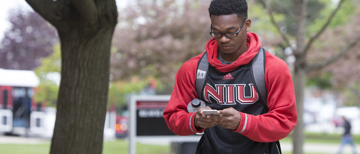 NIU Student with smartphone