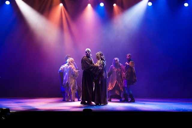 Group of theatre performers backlit in Rednoses performance