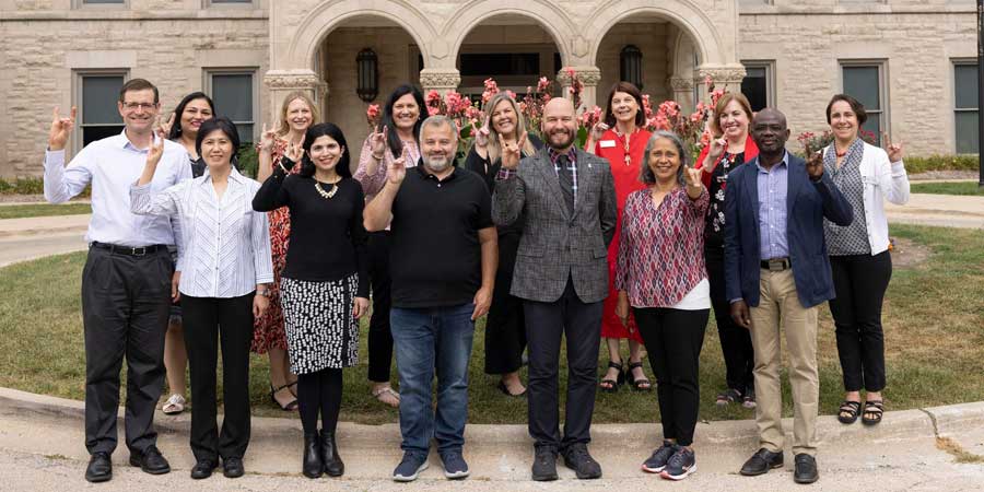 Group of NIU faculty posing in front of Altgeld Hall.