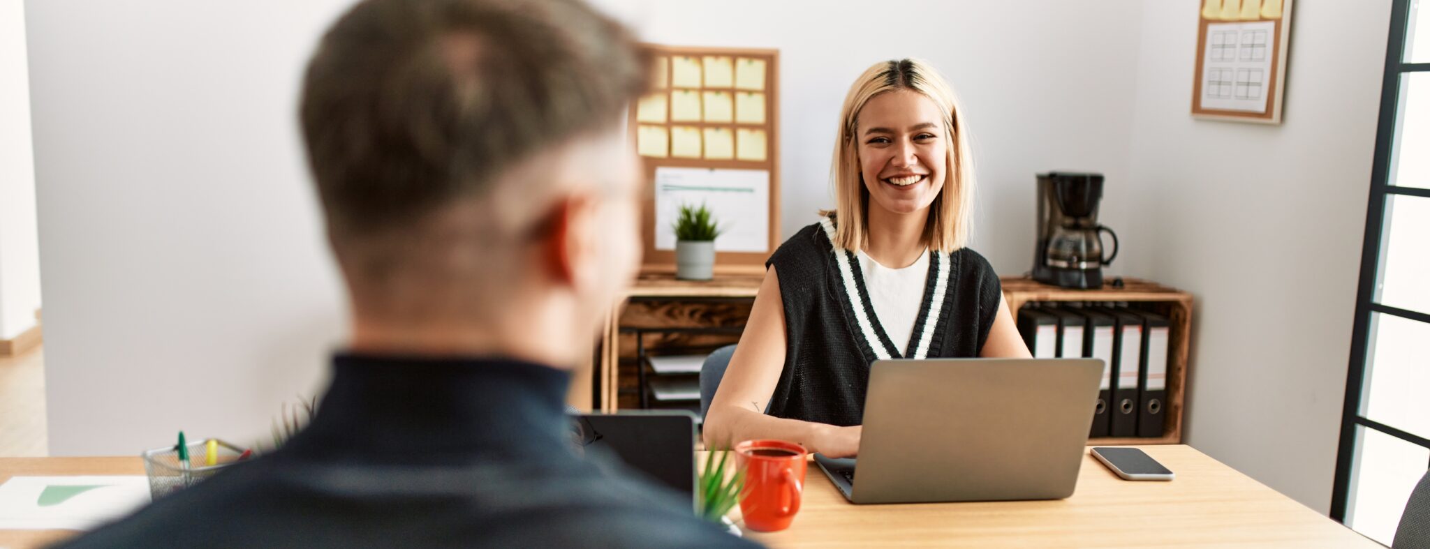 candidate interviewing for a job sitting at a desk with a computer