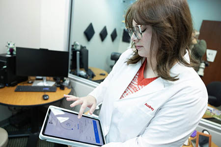 audiology student using tablet
