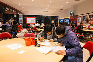 Students review information about a job fair at NIU