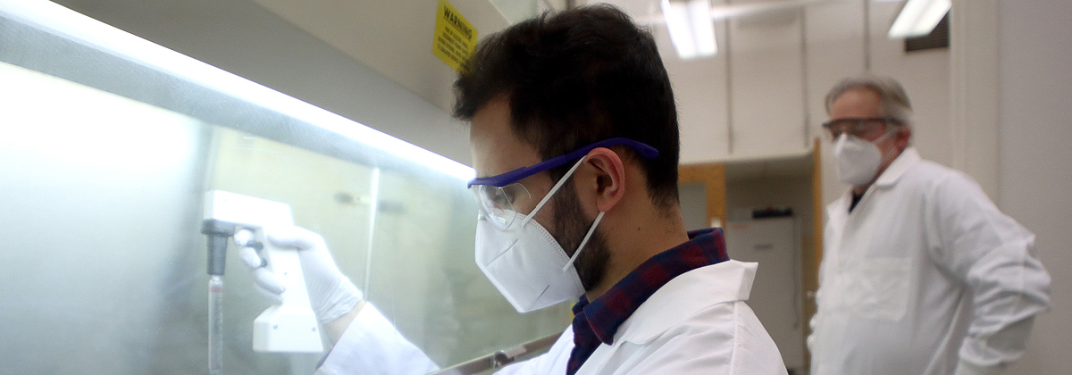 student and faculty member working in a lab