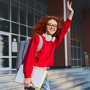 university student with a laptop and backpack, waving goody-bye