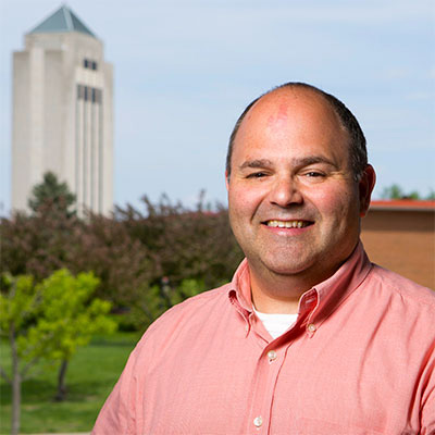 portrait of James Cohen in front of the Holmes Student Center