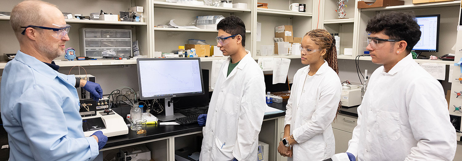 Students and a professor in a chemistry lab