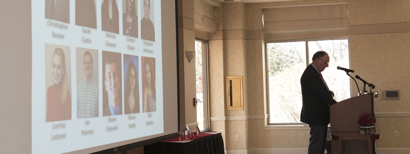 Presenter at podium in front of projection screen