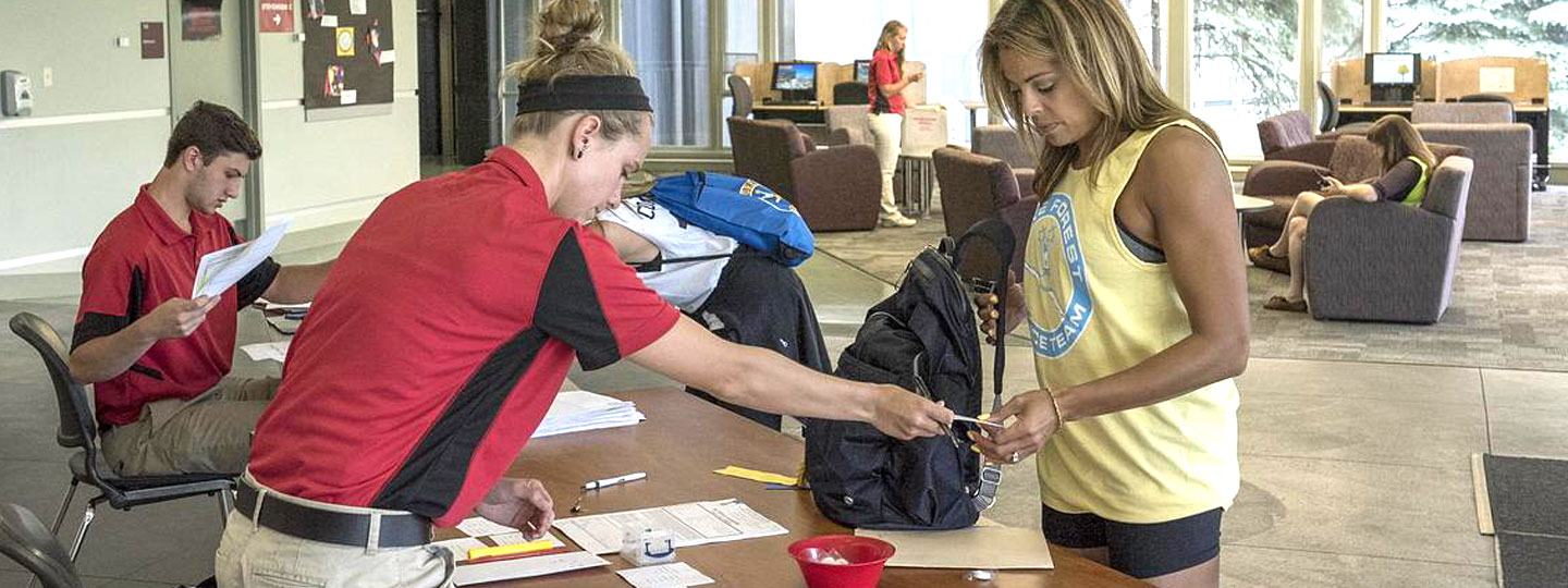 Woman checking in at registration table