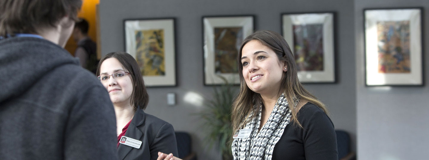 Event staff greeting attendee