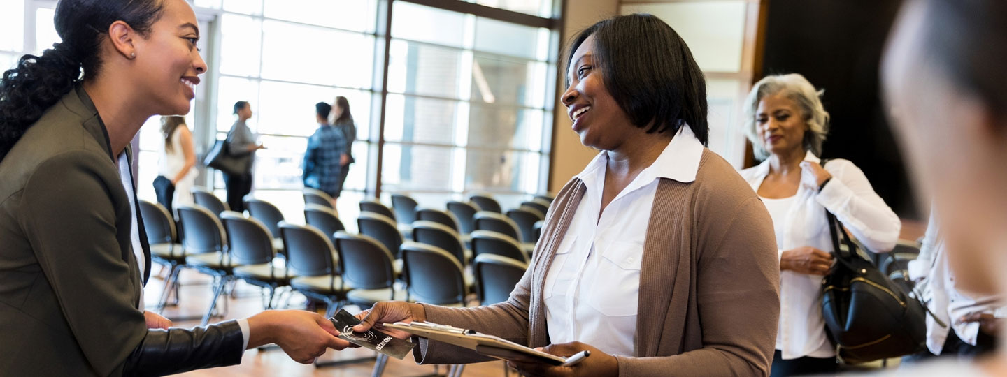 Smiling woman checks into a conference