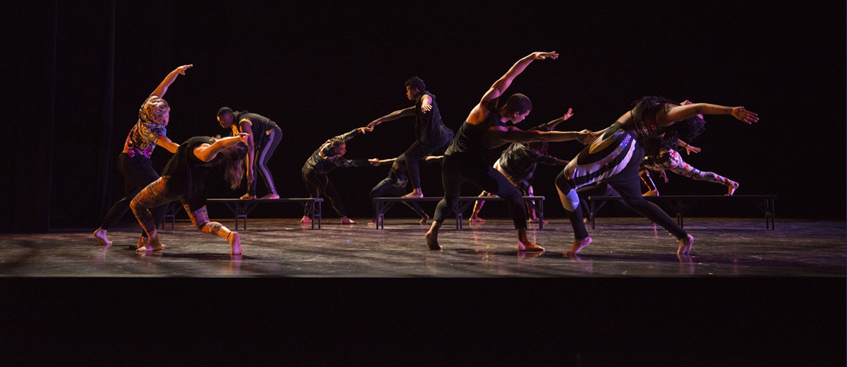 Dance group performing on stage.