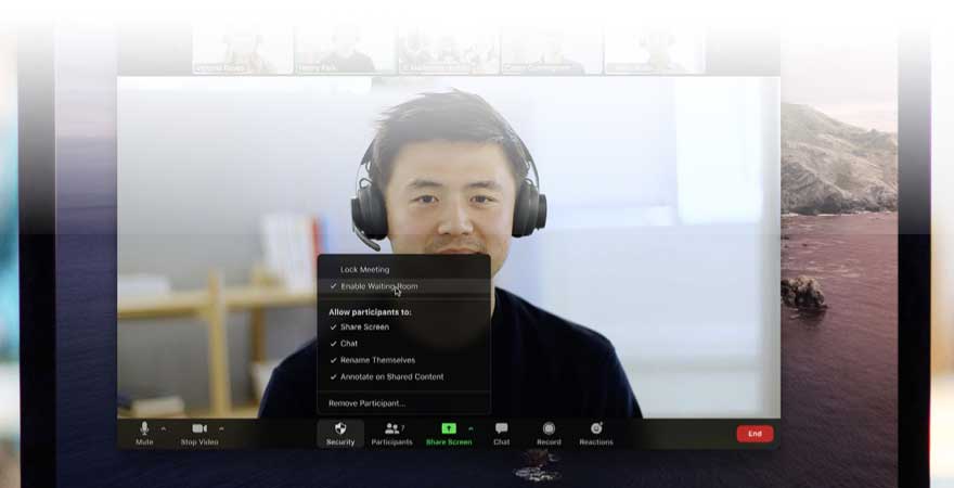 man looking at a computer monitor wearing headphones