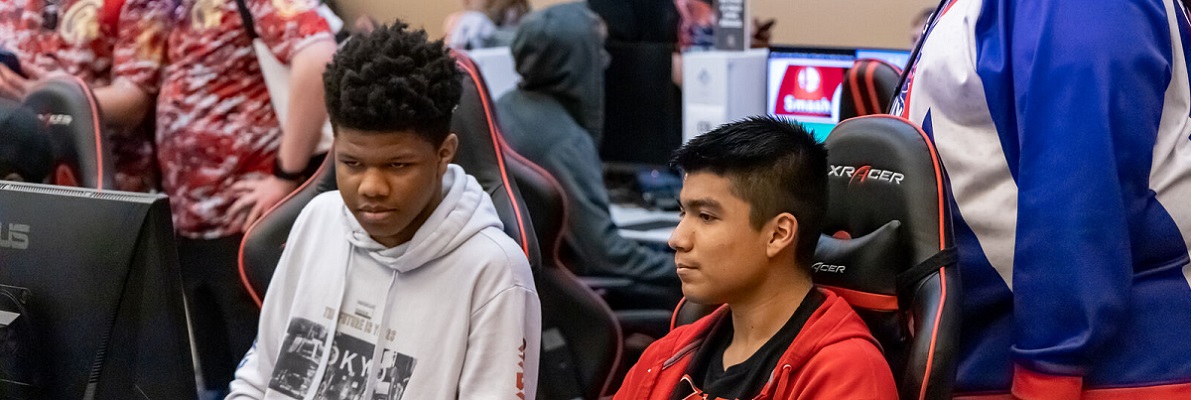 Students concentrate while playing video games on computers