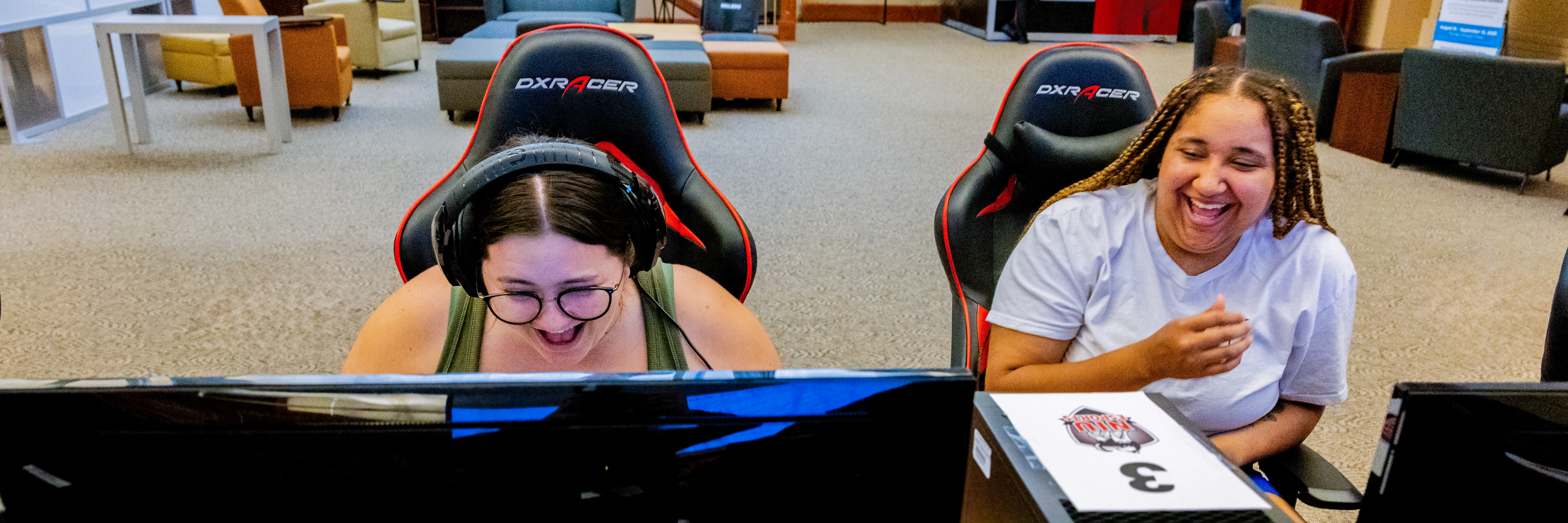 Two students have a blast playing games in the Esports Arena.