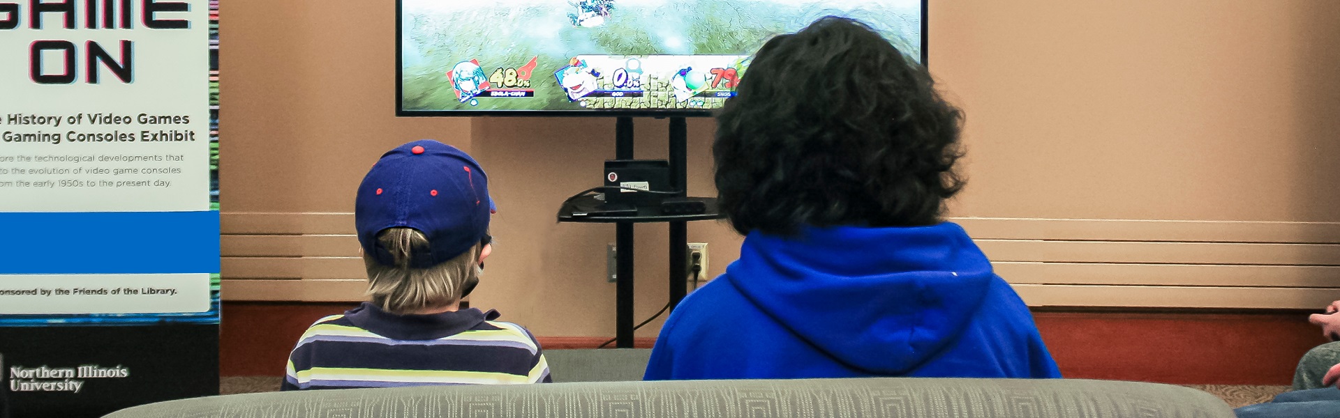 Community member and NIU student play video game together