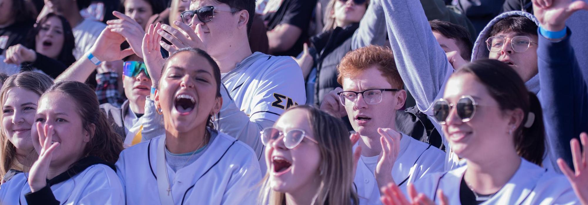 Students cheering on Tugs participants
