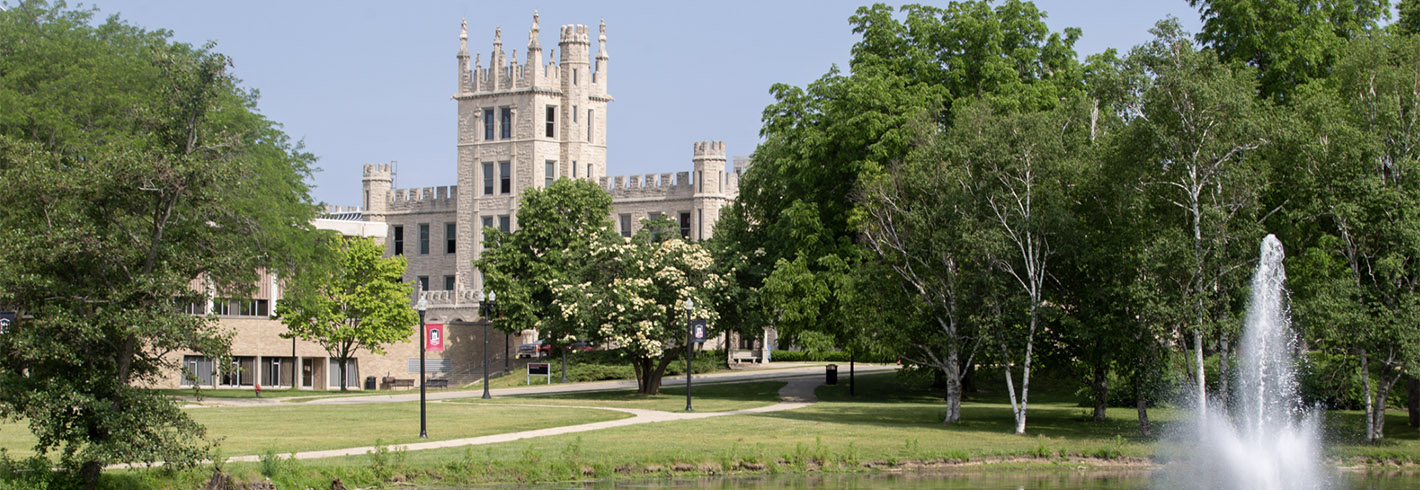 Altgeld Hall in summer, with fountain running in lagoon