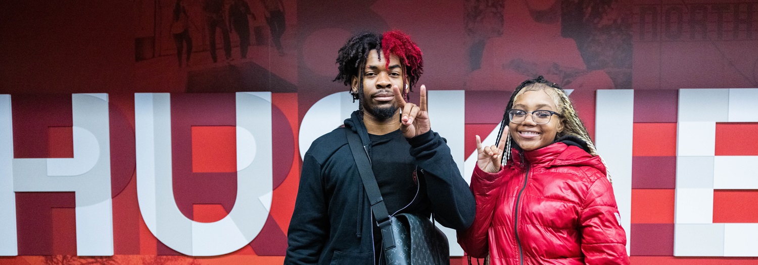 Two students showing their NIU spirit at the Holmes Student Center