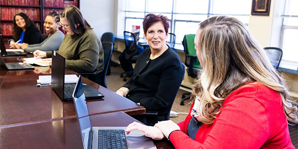 faculty committee members discussing at a conference table