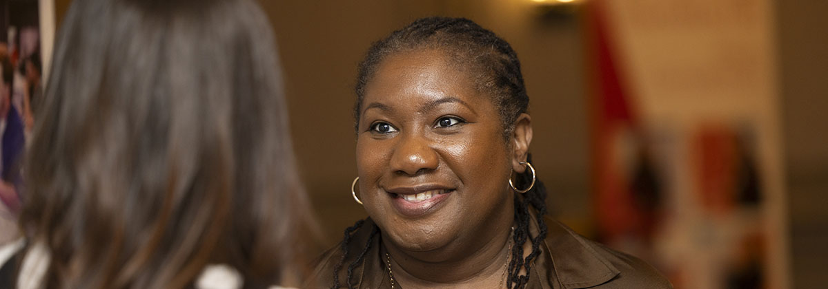 administrator smiling and speaking to an individual