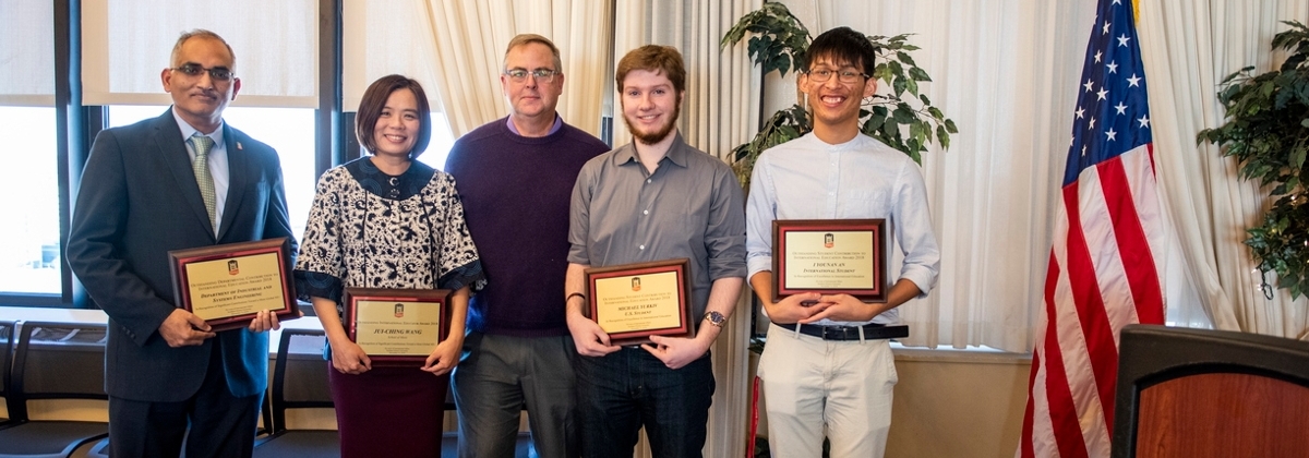 2018 award winners holding their plaques at the International Awards Recognition Reception