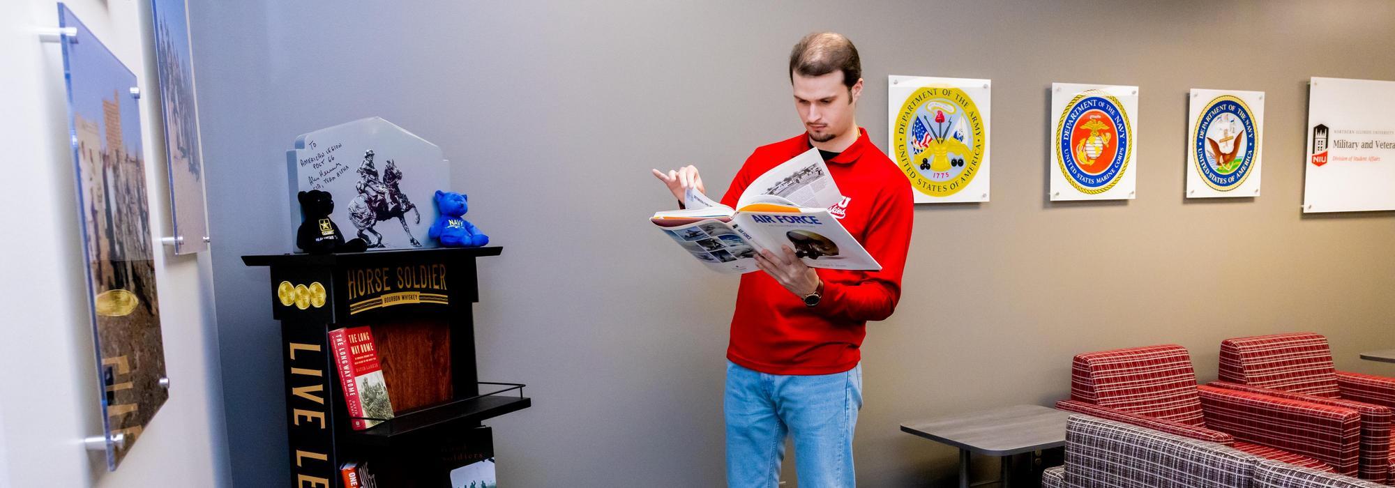 A student browses through a book in the Military and Veteran Services Office.