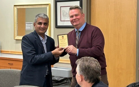 Dean Balaji Rajagopalan accepted award plaque from Dean Fred Barnhart