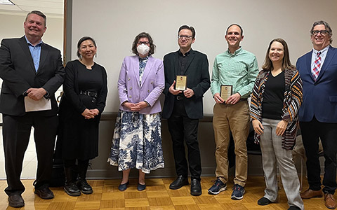 CLAS faculty and staff receiving award plaques from members of Course Materials Affordability Task Force