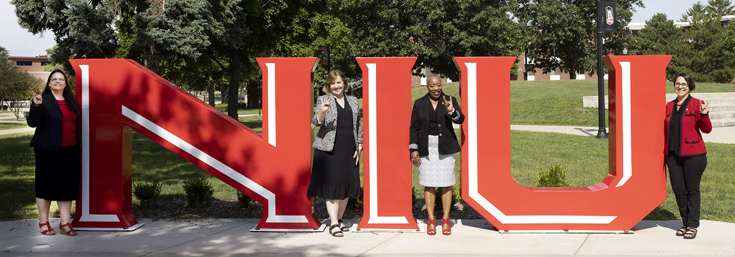 Provost leadership team in front of NIU letter sculpture.