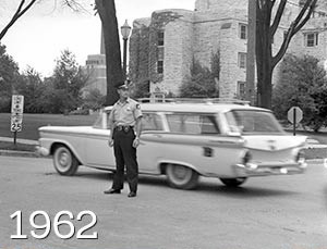 Police officer standing with vehicle