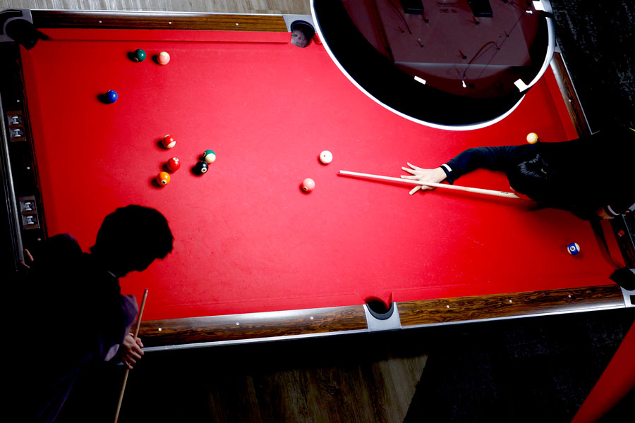 Students playing pool in Huskie Den