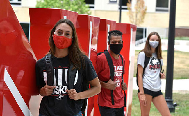 students on campus wearing masks